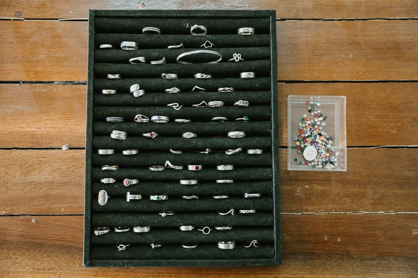 A tray of finished student rings in many different designs
