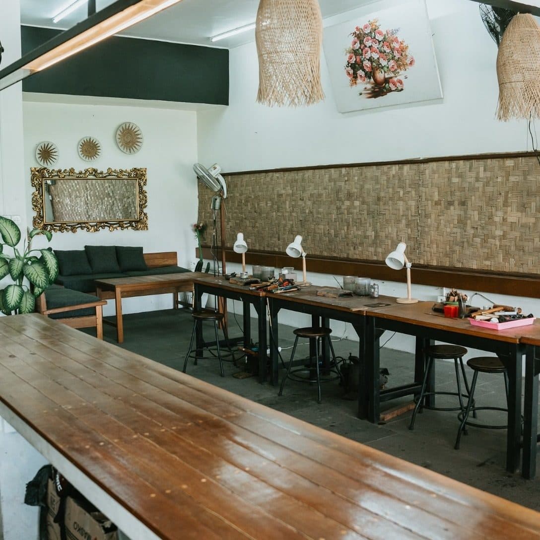 The Echo Silver air-conditioned studio with workbenches and rattan lamps