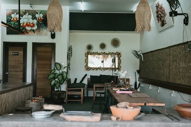 The Echo Silver Canggu studio with workbenches and rattan lamps
